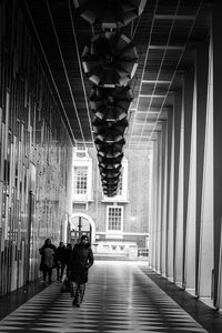 Rear view of woman walking in corridor