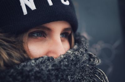 Close-up of thoughtful woman wearing warm clothing while looking away