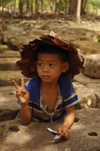 Portrait of cute boy holding camera