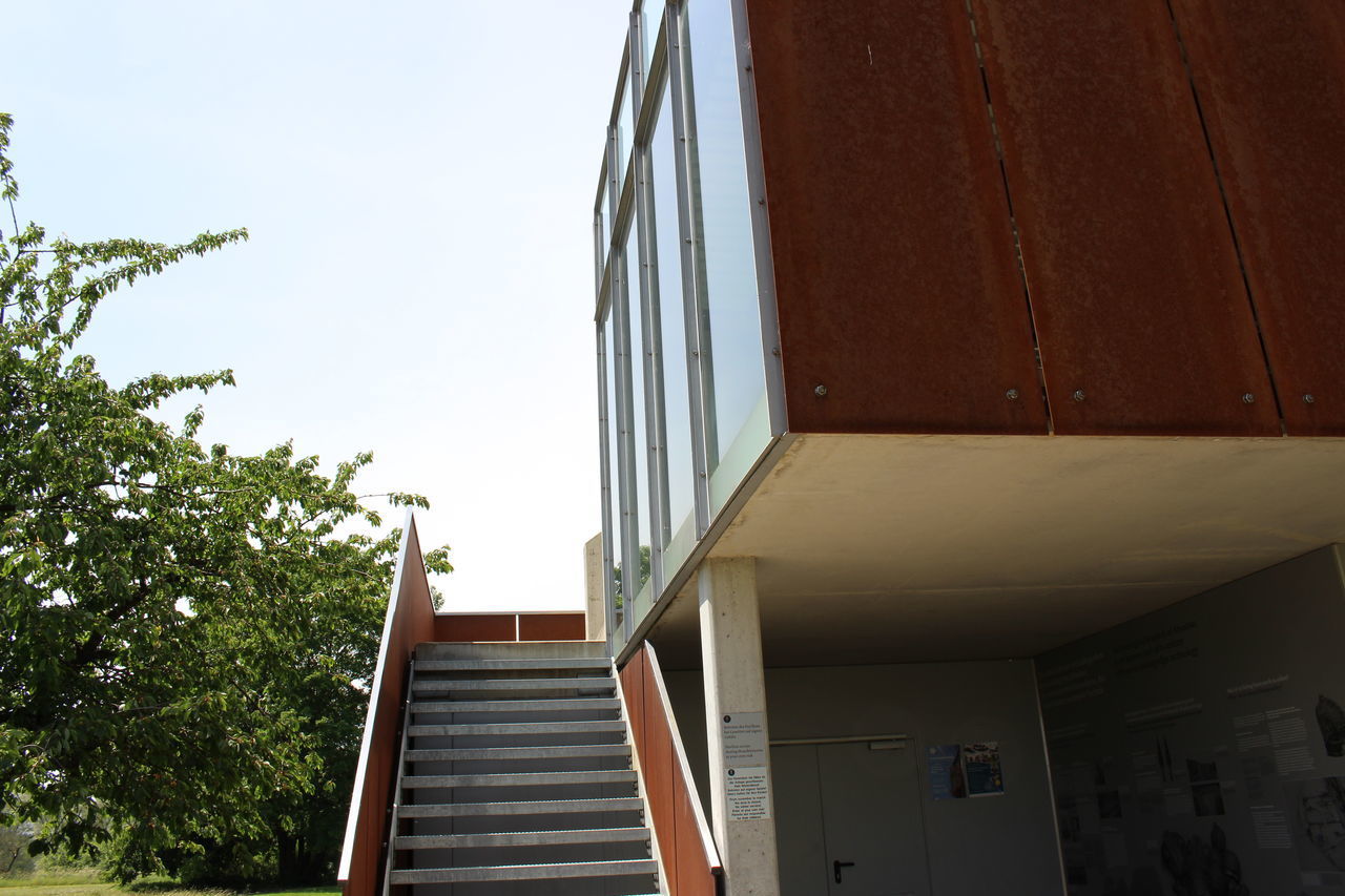 LOW ANGLE VIEW OF STAIRCASE AGAINST BUILDINGS