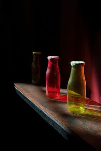 Close-up of drink in glass on table against black background