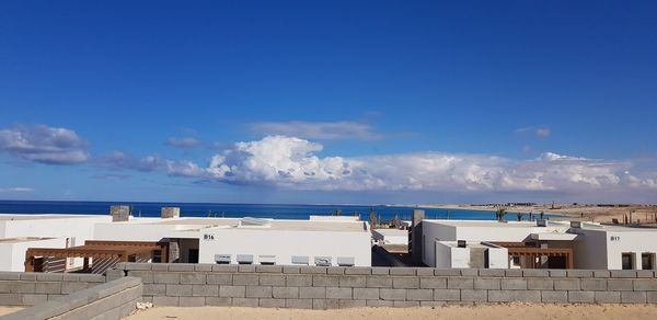 Panoramic view of buildings and sea against sky