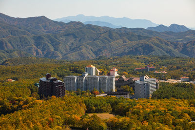 Buildings and mountains against sky