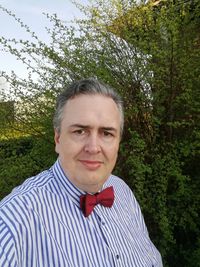 Portrait of man standing against plants