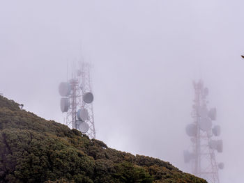 Low angle view of communications tower against sky