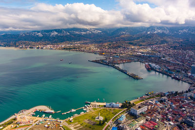 High angle view of buildings by sea against sky