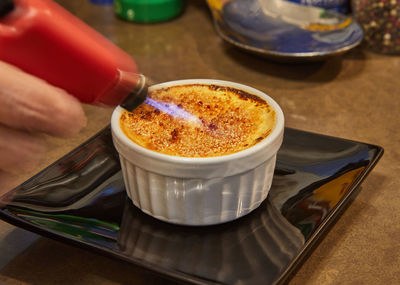 Creme brulee with mushrooms in special form, the chef burns sugar with burner. french gourmet 