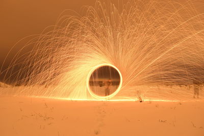 Man spinning wire wool on field during winter