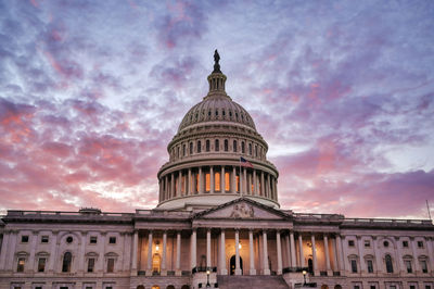 Low angle view of building against sky at sunset