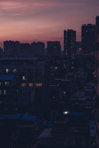 High angle view of illuminated buildings against sky at sunset