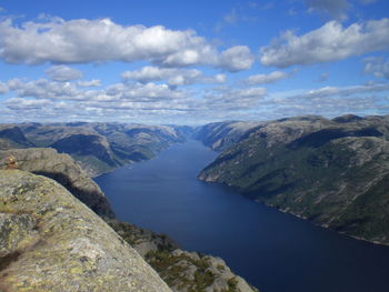 View of lysefjord from preikestolen against cloudy sky