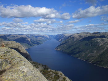 Scenic view of sea and mountains against sky