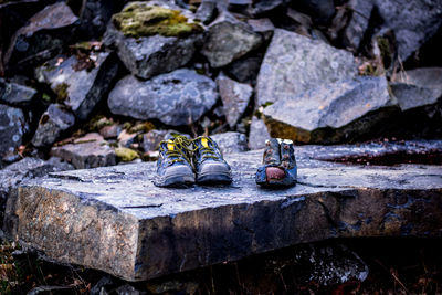 Abandoned shoes on rock