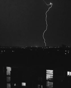 Illuminated city against sky at night