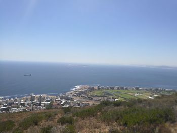 High angle view of cityscape by sea against sky