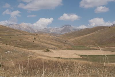 Scenic view of landscape and mountains against sky