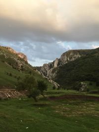 Scenic view of landscape against cloudy sky