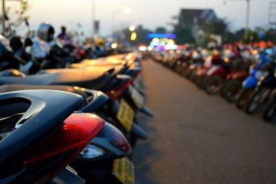 Motorcycles parked in parking lot during sunset