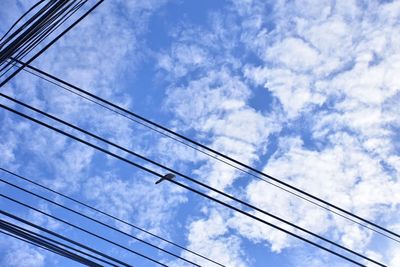 Low angle view of cables against blue sky