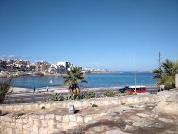 Scenic view of beach against clear blue sky