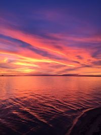 Scenic view of sea against romantic sky at sunset