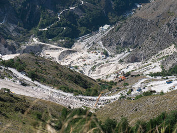 View of the carrara marble quarries and the transport trails carved into the side of the mountain.