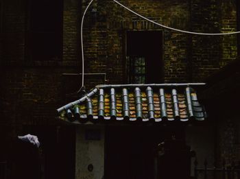 Abandoned building against wall at night