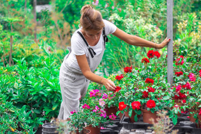 Full length of woman holding flower pot