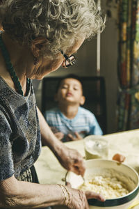 Man and woman sitting on table at home