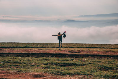 Young sporty girl goes running in the nature beautiful foggy morning moody atmosphere