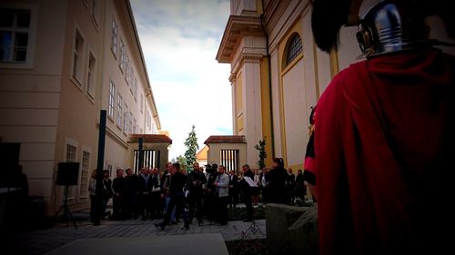 People standing outside temple against sky