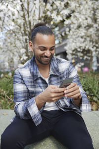 Smiling man using cell phone