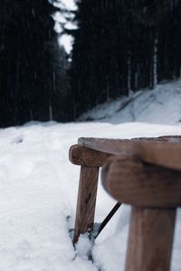 Wooden post on snow covered field during winter