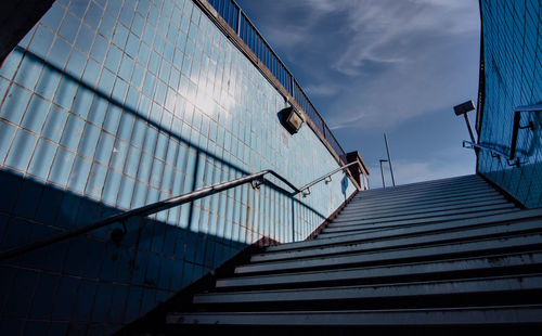 Low angle view of staircase by building against sky