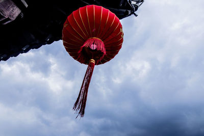 Low angle view of lantern hanging against sky