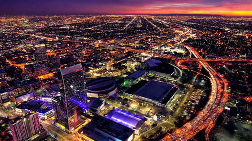 High angle view of city lit up at night