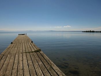 Pier over sea against sky