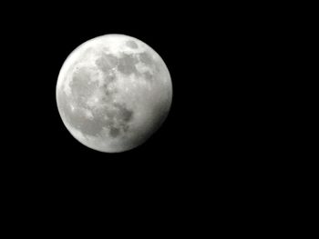 Low angle view of moon against sky at night