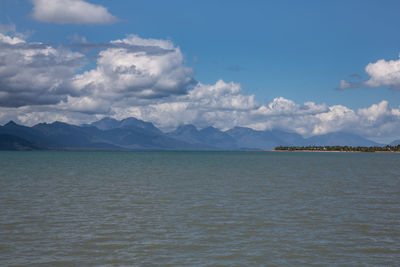 Scenic view of sea and mountains against sky