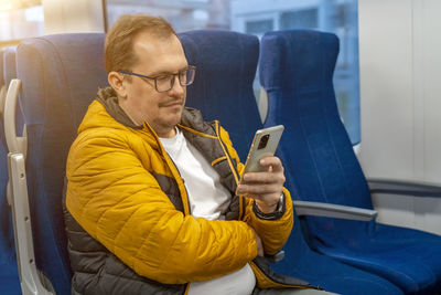 Side view of man using mobile phone