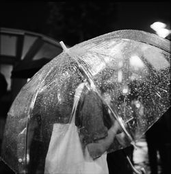 Close-up of wet man holding umbrella during rainy season