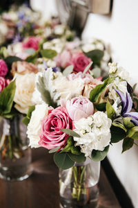 Close up of bridal wedding bouquet - pink peonies, rabbit ear plant, white hydrangea, purple lilies.