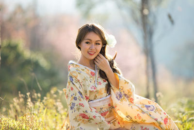 Portrait of smiling young woman outdoors