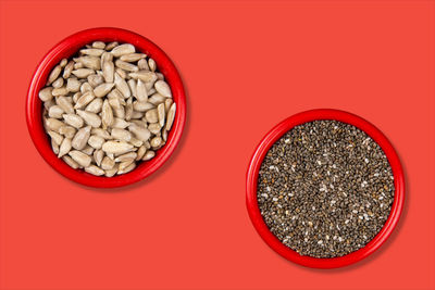 Directly above shot of pasta in bowl against red background