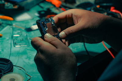 Cropped hand of person using mobile phone