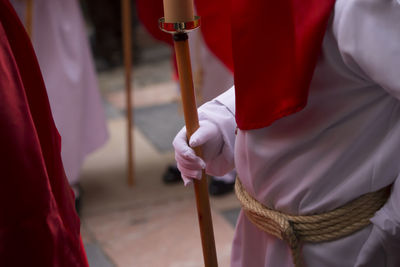 Close-up of hand holding red umbrella