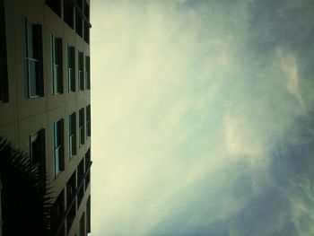 Low angle view of building against cloudy sky