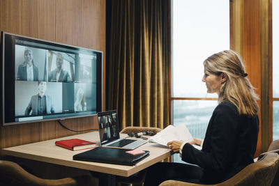 Female lawyer in video conference with colleagues in office during pandemic