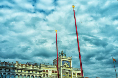 Low angle view of building against cloudy sky