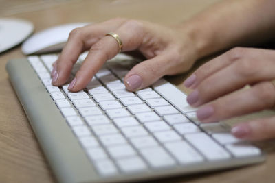 Midsection of person using laptop on table